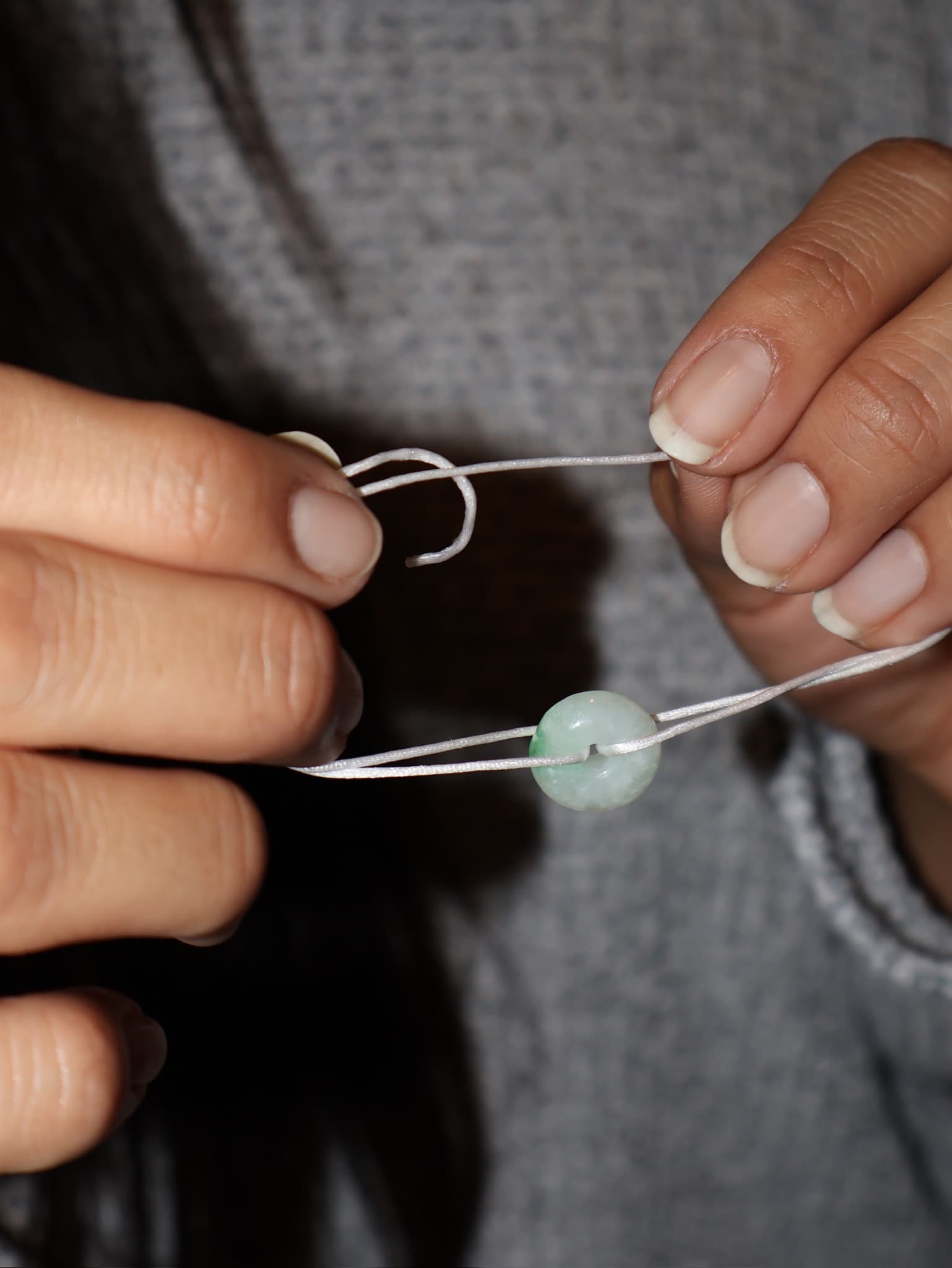 Jeweler finishing touches on a custom jade piece